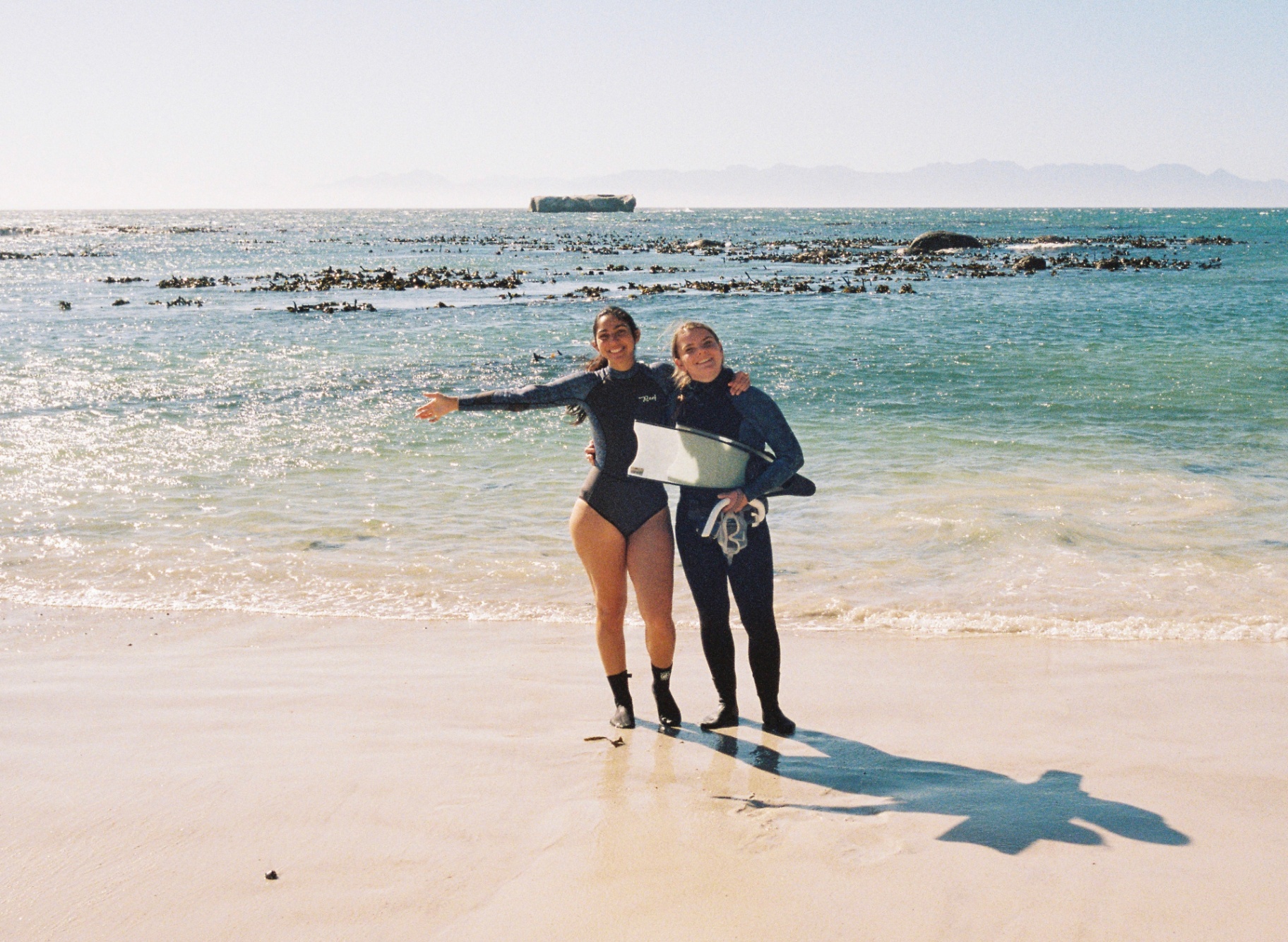 Two swimmers celebrating on the shore after a swim