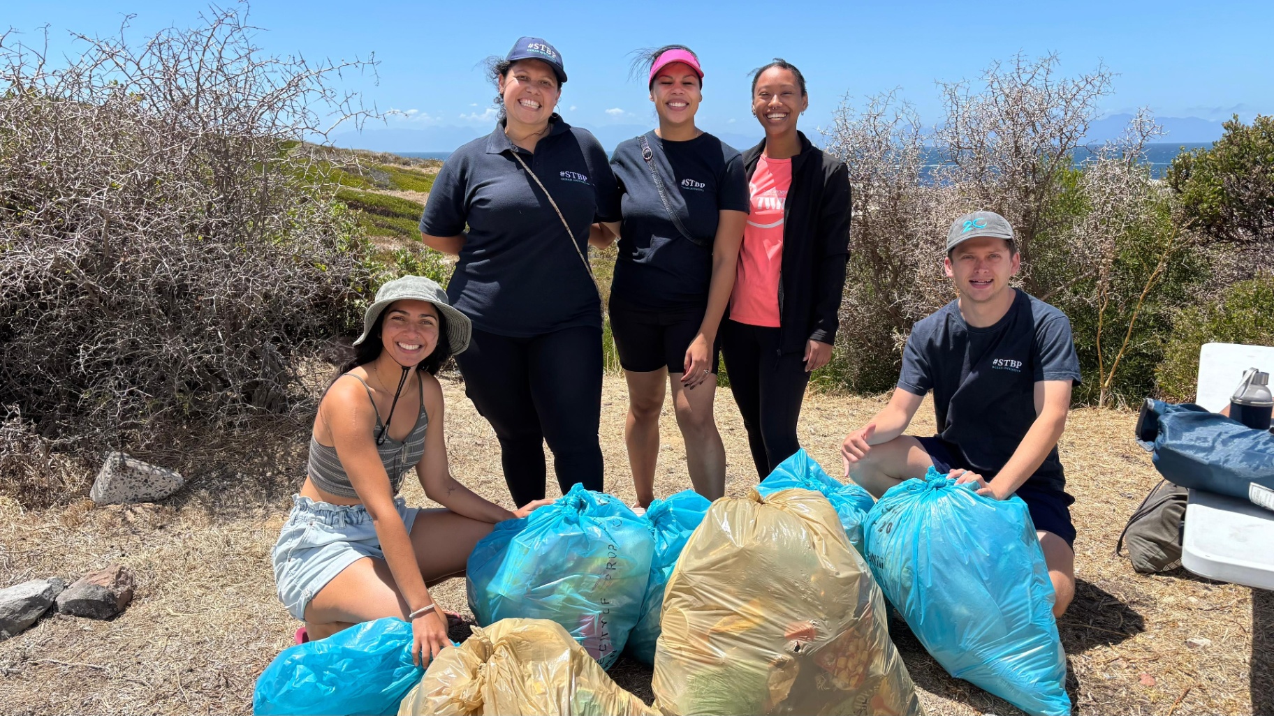 Sea The Bigger Picture team with bags of collected trash