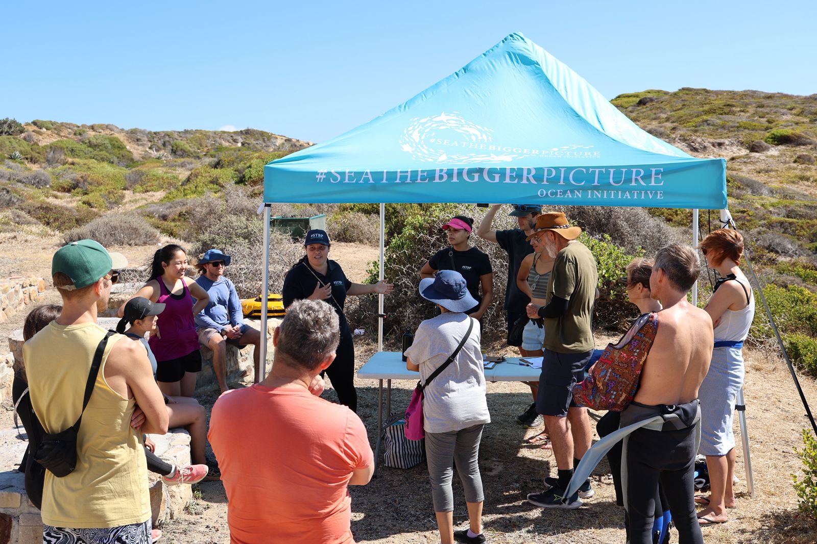 Cleanup briefing under the Sea The Bigger Picture tent