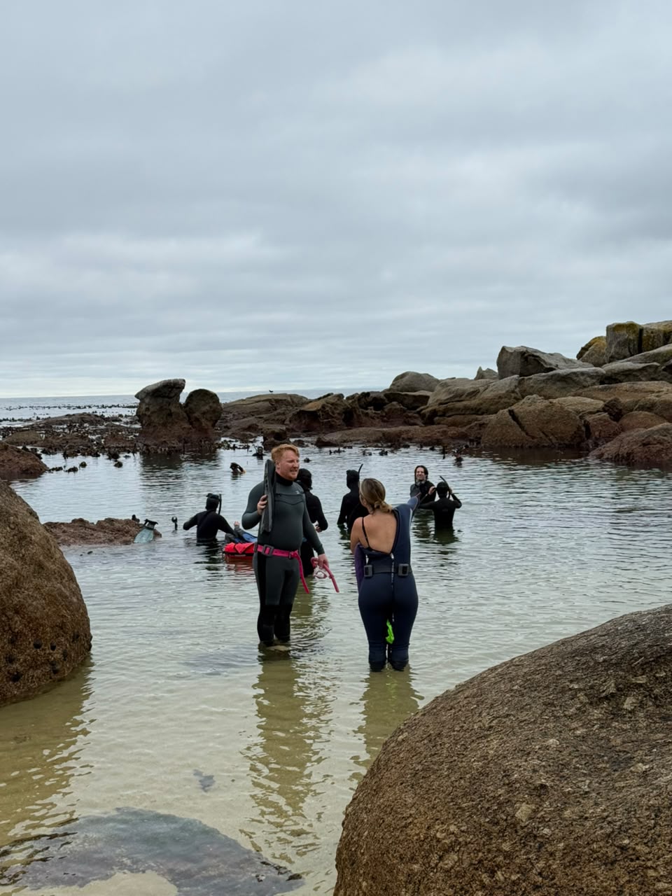 Freedivers gearing up in the shallows among the boulders