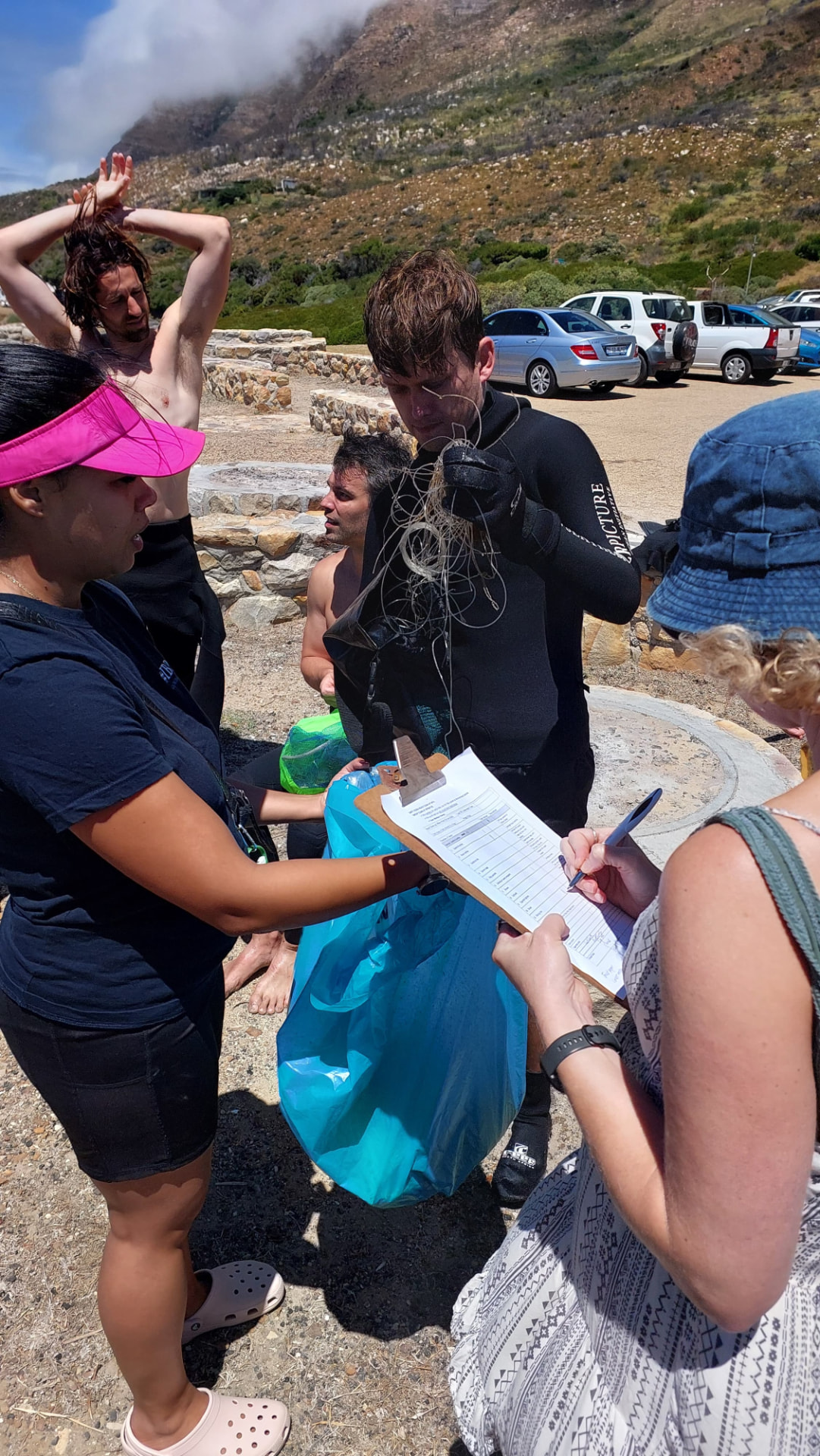 Volunteers logging collected rope and debris after a cleanup