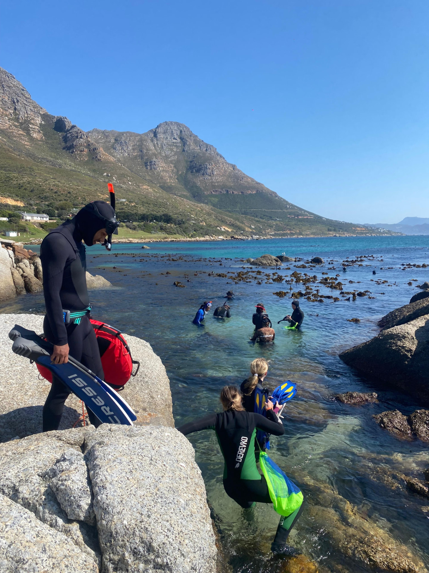 Crew entering the shallows at Miller's Point with fins and catch bags