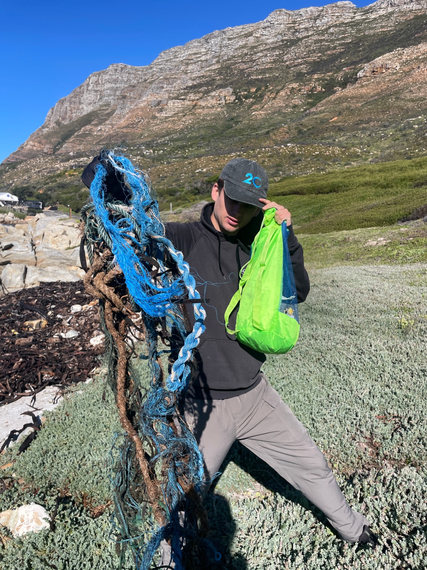 Volunteer hauling a tangle of rope and ghost net off the coast